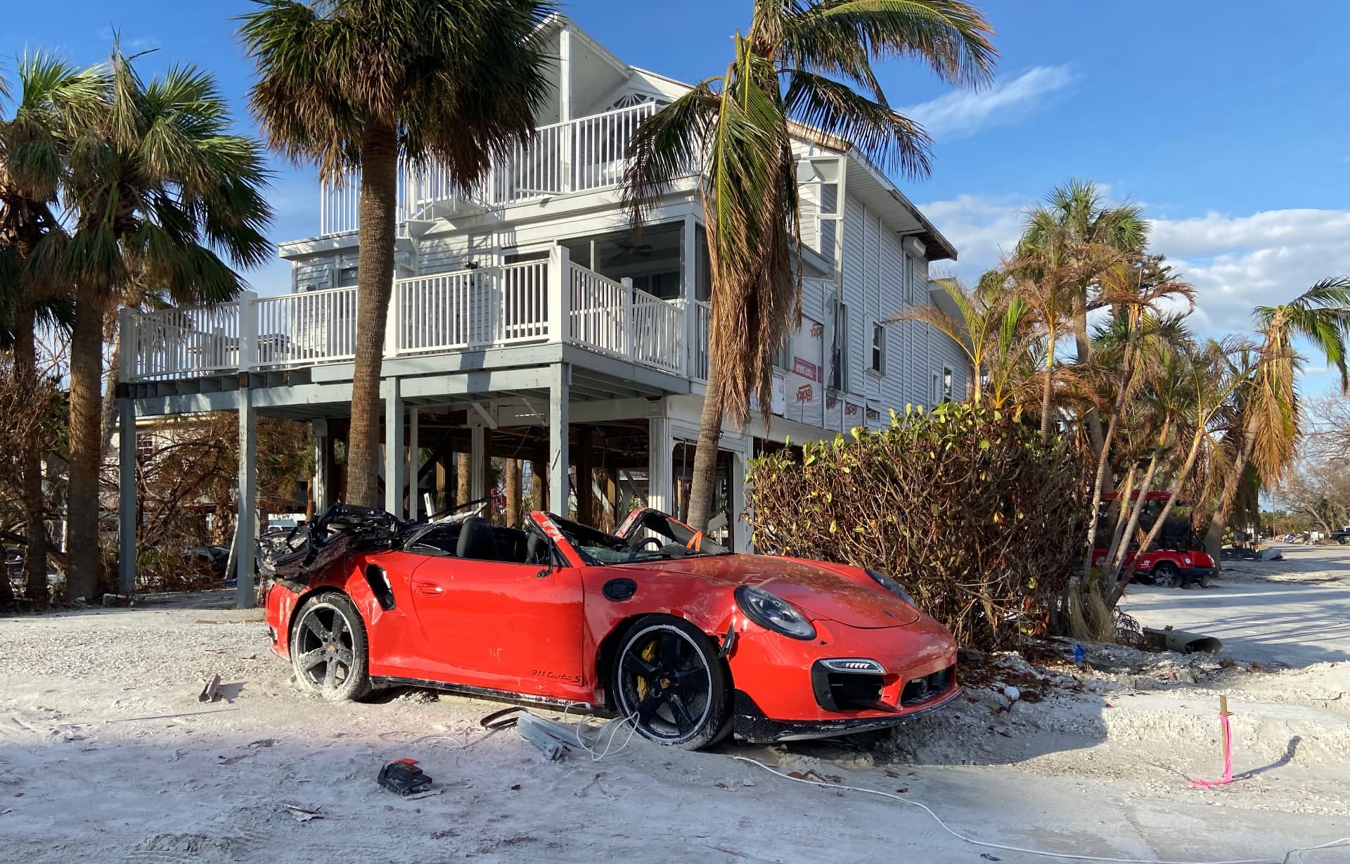 Red Porsche outside a storm-damaged home in Fort Myers, Florida, October 2022